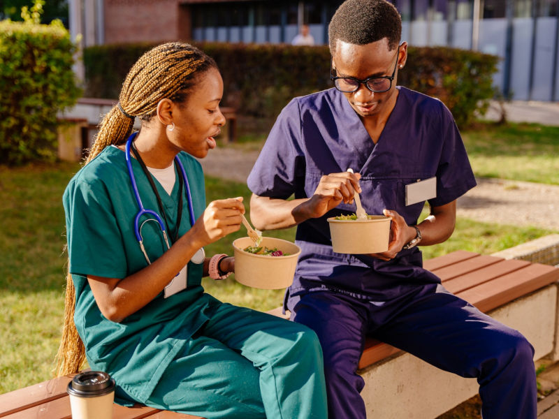 two,medical,professional,in,uniforms,having,lunch,time,,enjoying,time